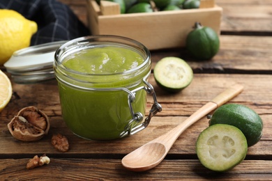 Feijoa jam in glass jar on wooden table Photo of Feijoa jam in glass jar on wooden table