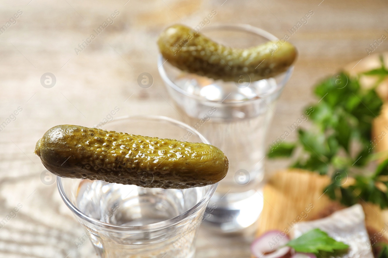 Cold Russian vodka with pickles on table, closeup Photo of Cold Russian vodka with pickles on table, closeup
