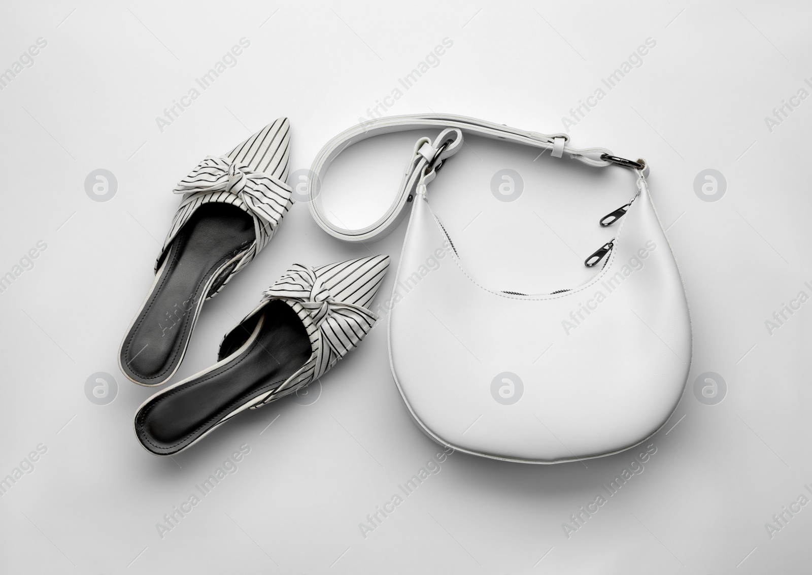 Stylish woman's bag and shoes on light background, flat lay Photo of Stylish woman's bag and shoes on light background, flat lay