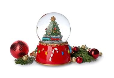 Beautiful snow globe, Christmas balls and coniferous twigs on white background Photo of Beautiful snow globe, Christmas balls and coniferous twigs on white background