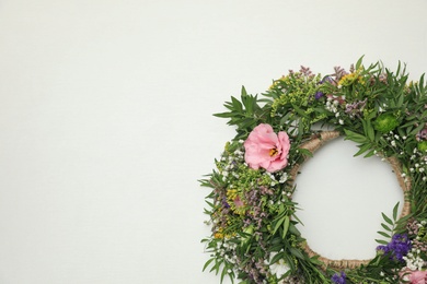 Wreath made of beautiful flowers on white background, top view. Space for text Photo of Wreath made of beautiful flowers on white background, top view. Space for text
