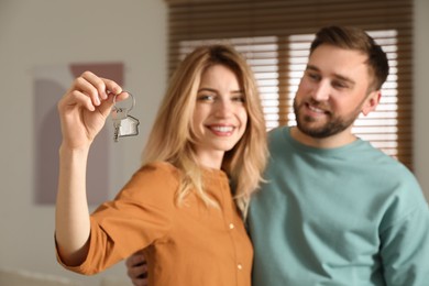 Happy young couple with key in new house, focus on hand Photo of Happy young couple with key in new house, focus on hand