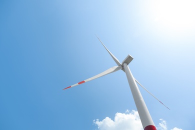 Modern wind turbine against blue sky, low angle view. Energy efficiency Photo of Modern wind turbine against blue sky, low angle view. Energy efficiency