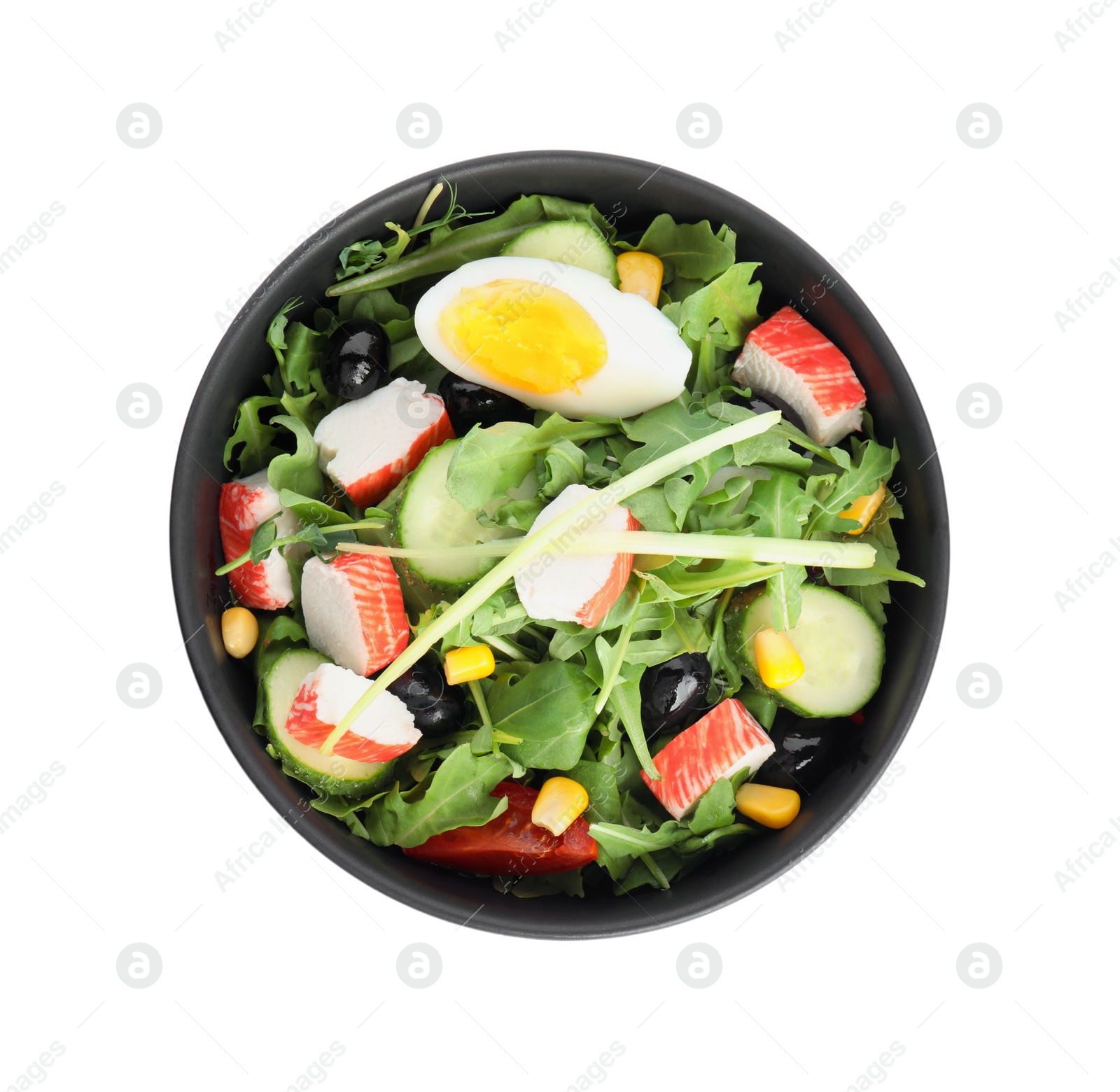 Tasty crab stick salad in bowl isolated on white, top view Photo of Tasty crab stick salad in bowl isolated on white, top view