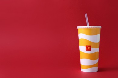 MYKOLAIV, UKRAINE - AUGUST 12, 2021: Cold McDonald's drink on red background. Space for text Photo of MYKOLAIV, UKRAINE - AUGUST 12, 2021: Cold McDonald's drink on red background. Space for text