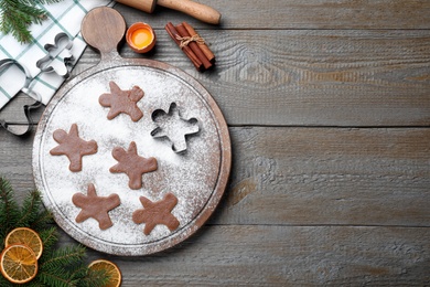 Flat lay composition with homemade gingerbread man cookies on wooden table, space for text Photo of Flat lay composition with homemade gingerbread man cookies on wooden table, space for text