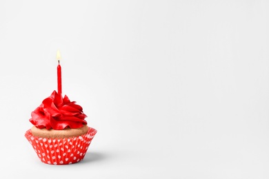 Birthday cupcake with candle on white background Photo of Birthday cupcake with candle on white background