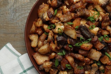 Tasty fried cracklings on wooden table, top view. Cooked pork lard Photo of Tasty fried cracklings on wooden table, top view. Cooked pork lard