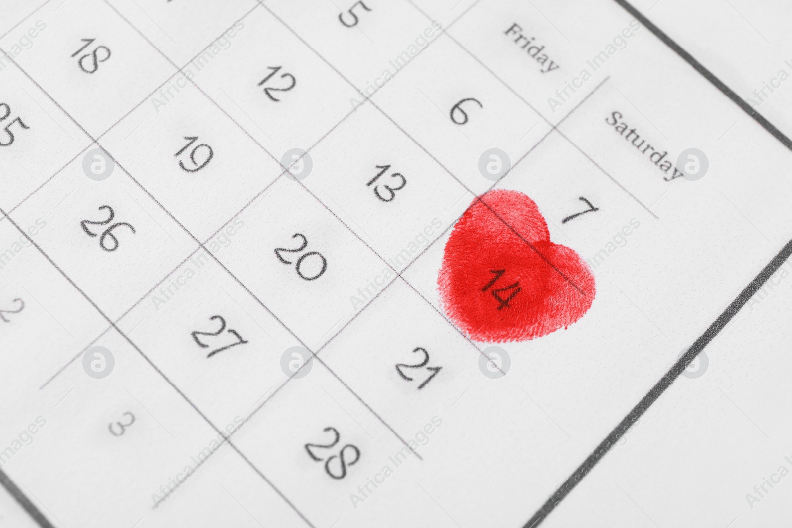 Valentine's day marked with red fingerprints on calendar sheet Photo of Valentine's day marked with red fingerprints on calendar sheet