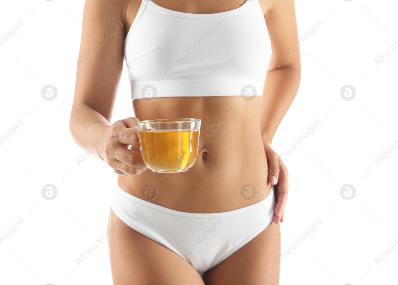 Young woman holding cup of diet tea on white background, closeup Photo of Young woman holding cup of diet tea on white background, closeup