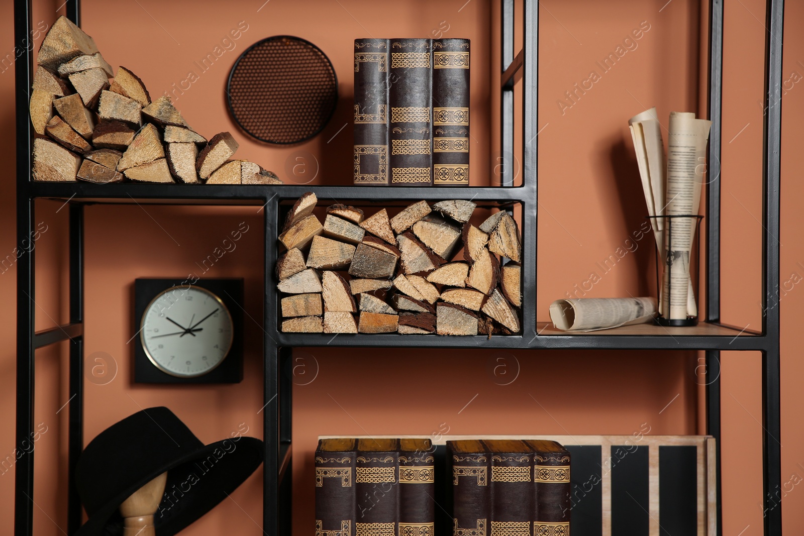 Stylish shelving unit with decorative elements near color wall. Interior design Photo of Stylish shelving unit with decorative elements near color wall. Interior design