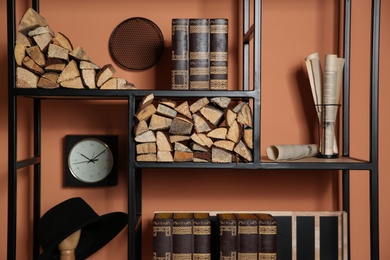 Stylish shelving unit with decorative elements near color wall. Interior design Photo of Stylish shelving unit with decorative elements near color wall. Interior design