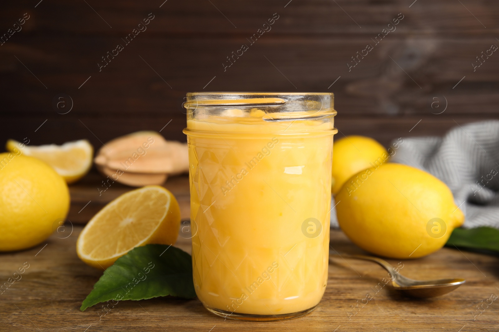 Delicious lemon curd and fresh fruits on wooden table Photo of Delicious lemon curd and fresh fruits on wooden table