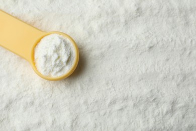 Top view of powdered infant formula and scoop, space for text. Baby milk Photo of Top view of powdered infant formula and scoop, space for text. Baby milk