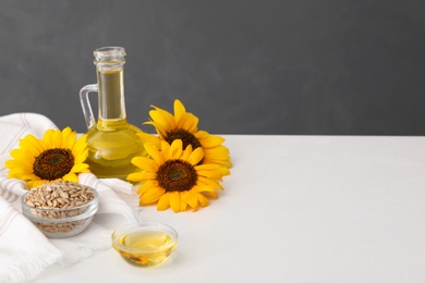 Composition with sunflower oil on white table, space for text Photo of Composition with sunflower oil on white table, space for text