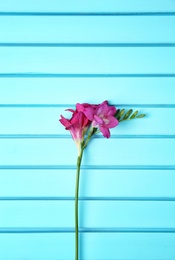 Beautiful freesia on wooden background Photo of Beautiful freesia on wooden background
