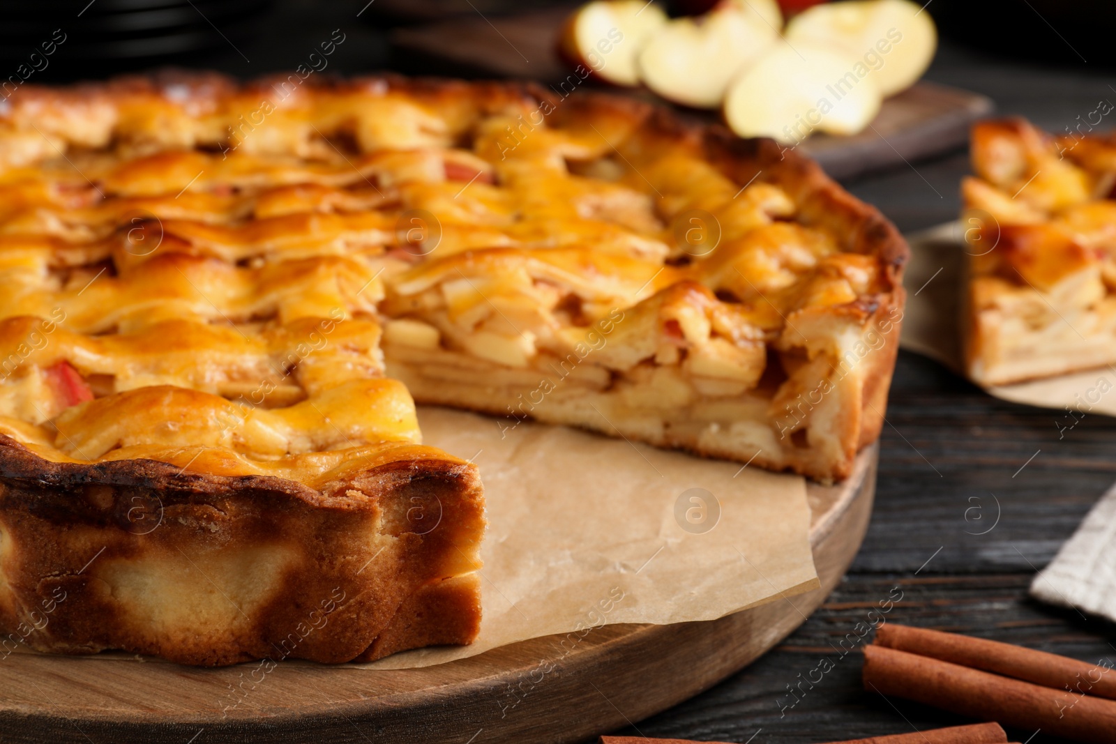 Traditional apple pie on black wooden table, closeup Photo of Traditional apple pie on black wooden table, closeup