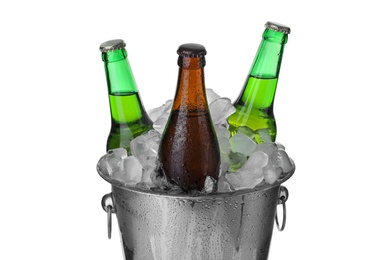Metal bucket with bottles of beer and ice cubes isolated on white Photo of Metal bucket with bottles of beer and ice cubes isolated on white