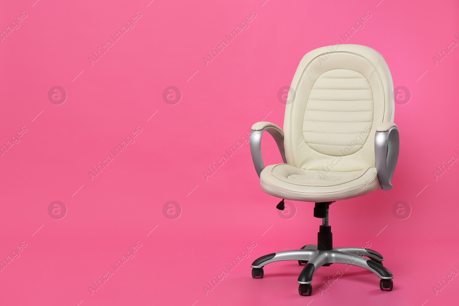 Comfortable office chair on pink background, space for text Photo of Comfortable office chair on pink background, space for text
