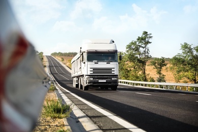 Beautiful view of asphalt highway with truck. Road trip Photo of Beautiful view of asphalt highway with truck. Road trip