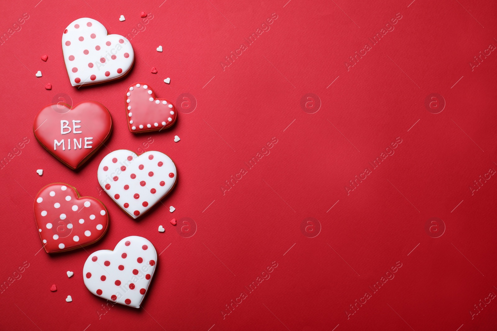 Photo of Valentine's day cookies on red background, flat lay. Space for text