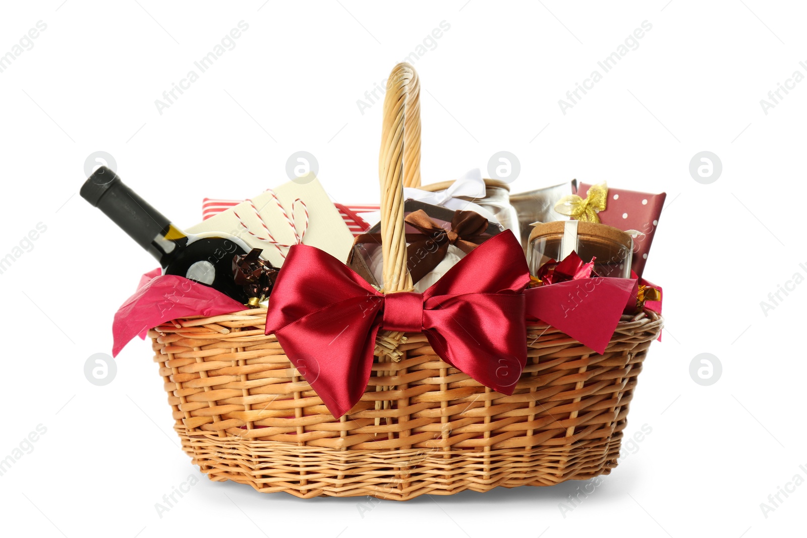Wicker basket full of gifts isolated on white Photo of Wicker basket full of gifts isolated on white