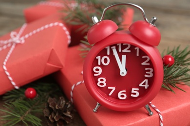 Beautiful composition with alarm clock and Christmas gifts, closeup. Boxing day Photo of Beautiful composition with alarm clock and Christmas gifts, closeup. Boxing day