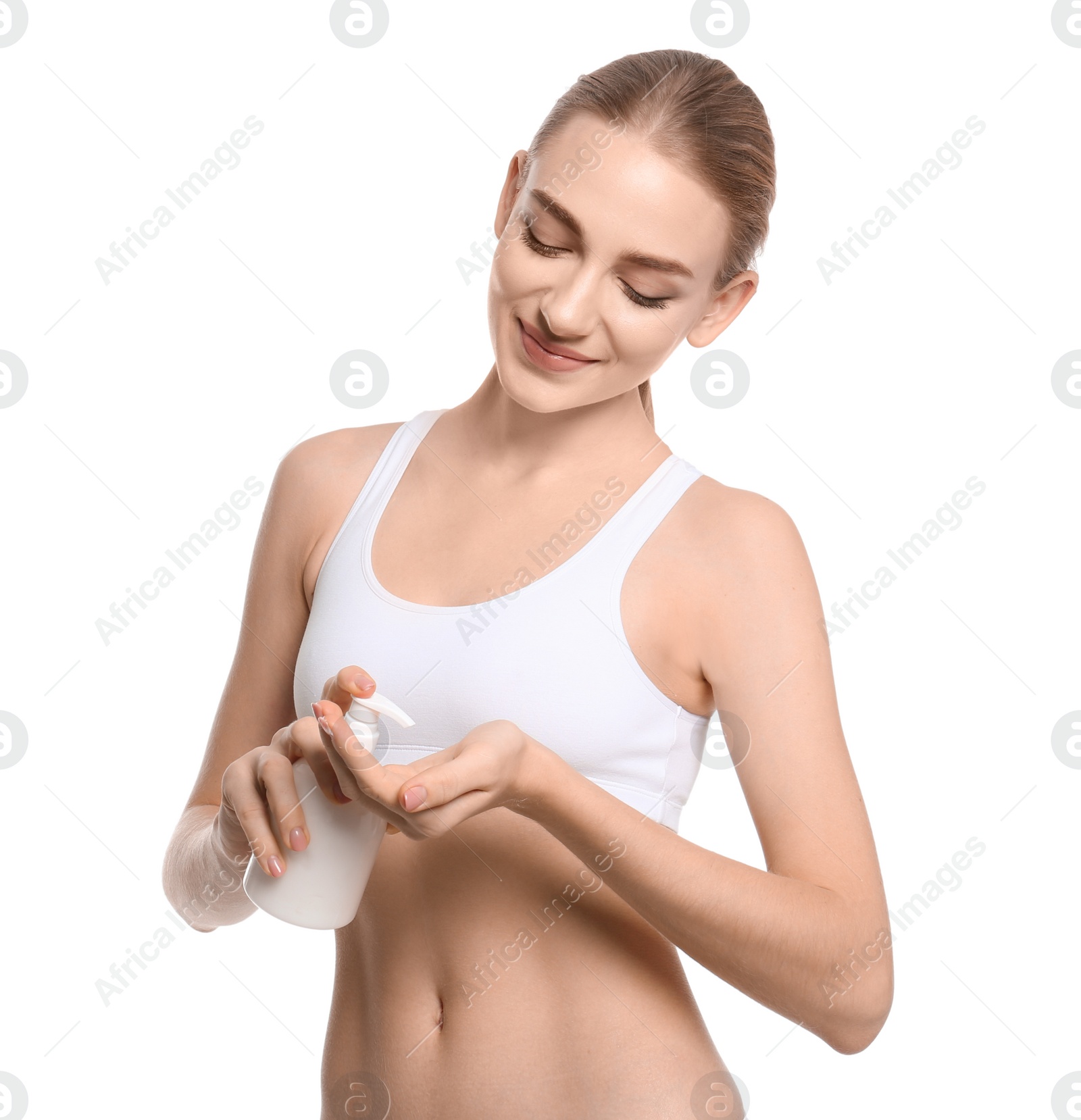 Young woman with bottle of body cream on white background Photo of Young woman with bottle of body cream on white background