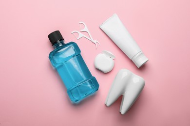 Flat lay composition with mouthwash and other oral hygiene products on pink background Photo of Flat lay composition with mouthwash and other oral hygiene products on pink background