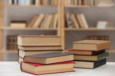 Many books on white table in library Photo of Many books on white table in library