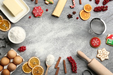 Frame of Christmas cookies and flour on grey table, flat lay. Space for text Photo of Frame of Christmas cookies and flour on grey table, flat lay. Space for text