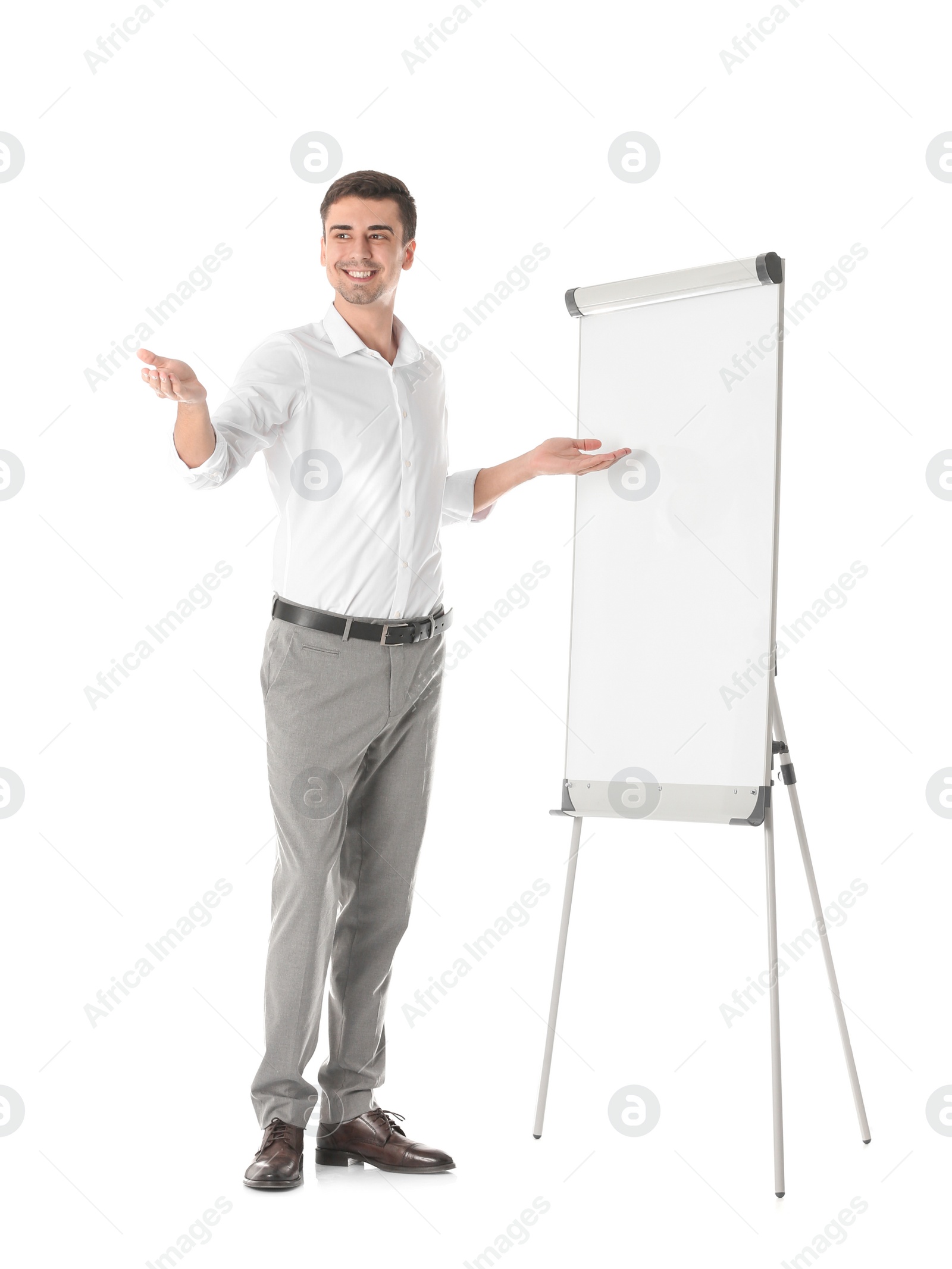 Business trainer giving presentation on flip chart board against white background Photo of Business trainer giving presentation on flip chart board against white background