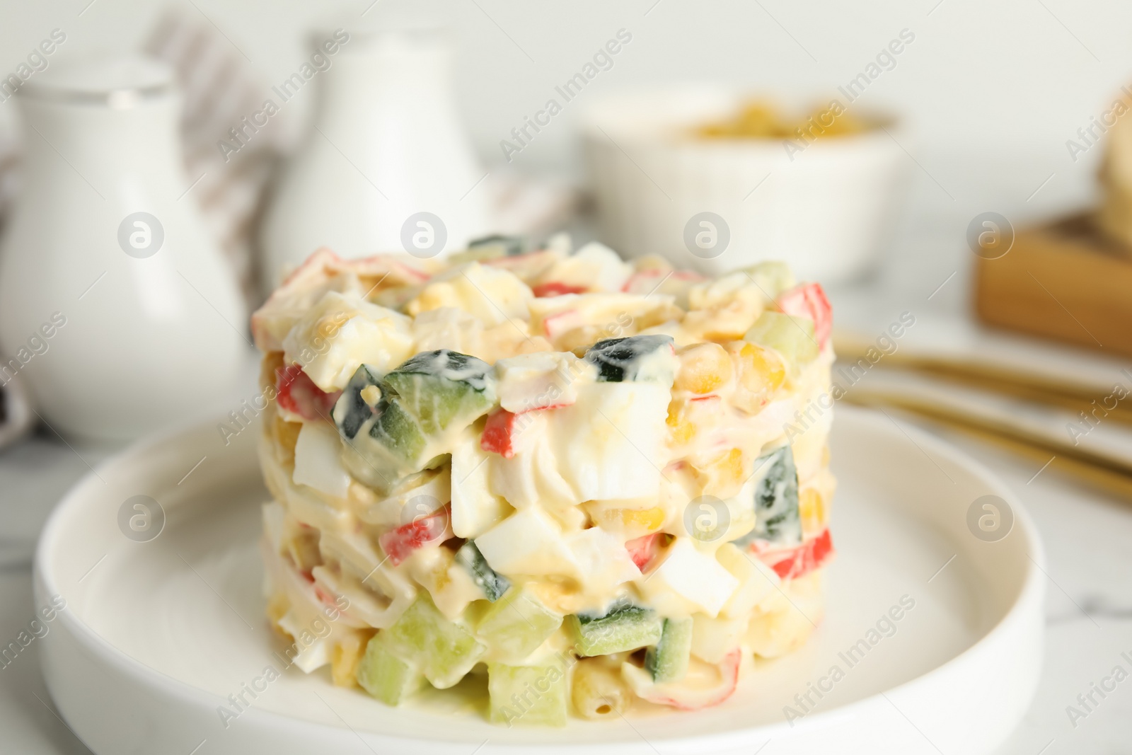 Delicious salad with fresh crab sticks on plate, closeup Photo of Delicious salad with fresh crab sticks on plate, closeup