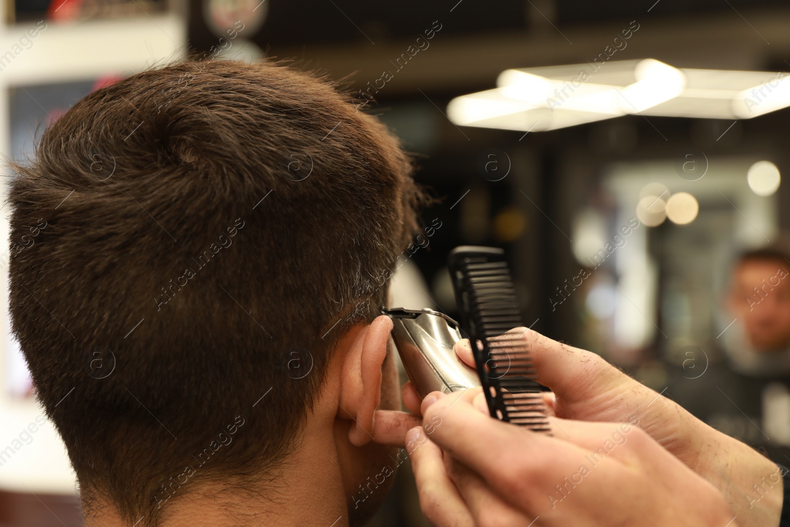 Professional hairdresser making stylish haircut in salon, closeup Photo of Professional hairdresser making stylish haircut in salon, closeup