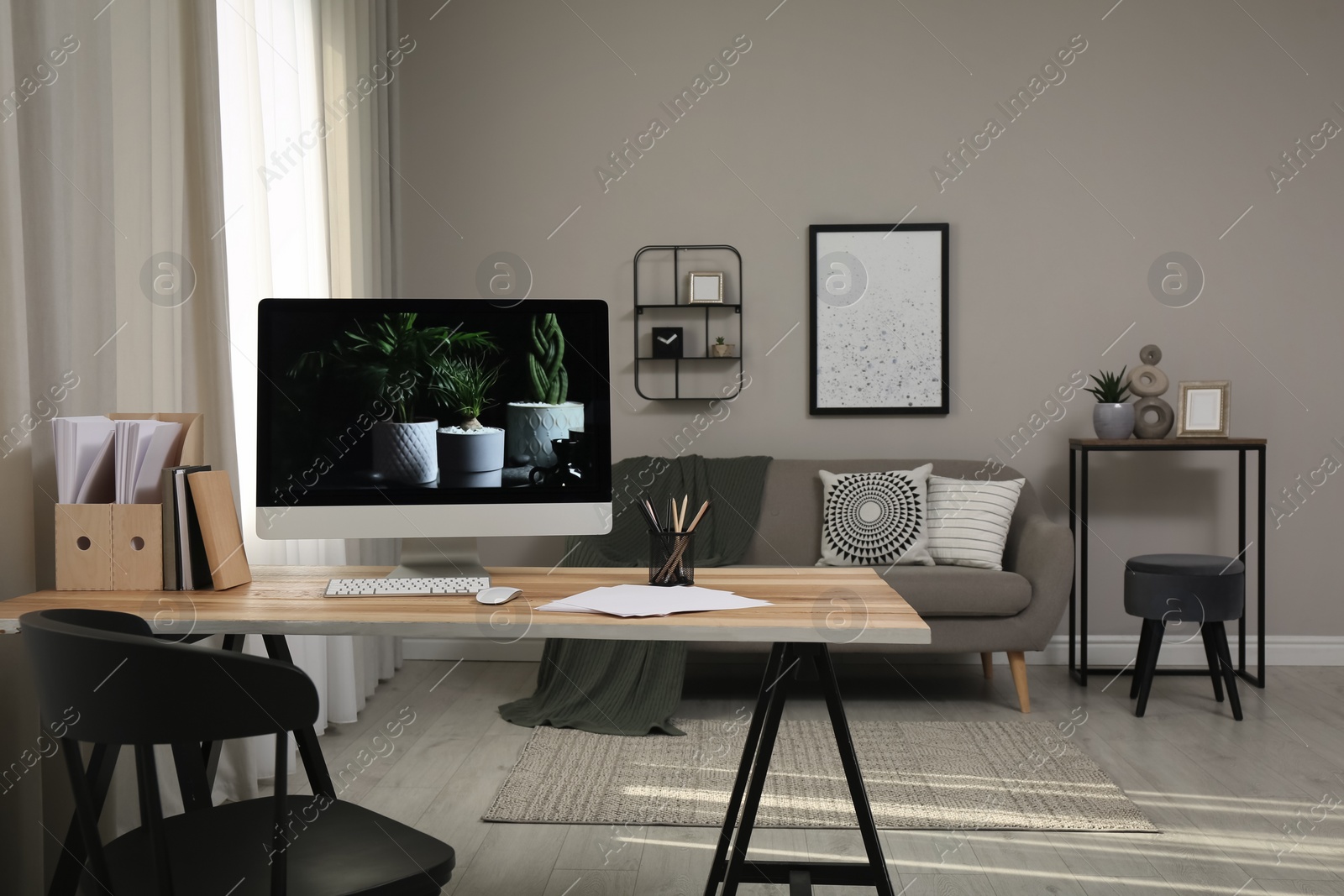 Comfortable workplace with computer on wooden desk in modern office. Interior design Photo of Comfortable workplace with computer on wooden desk in modern office. Interior design