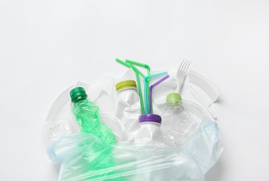 Pile of different plastic items on white background, flat lay Photo of Pile of different plastic items on white background, flat lay
