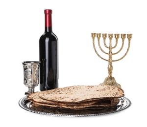 Tasty matzos, wine and menorah on white background. Passover (Pesach) celebration Photo of Tasty matzos, wine and menorah on white background. Passover (Pesach) celebration