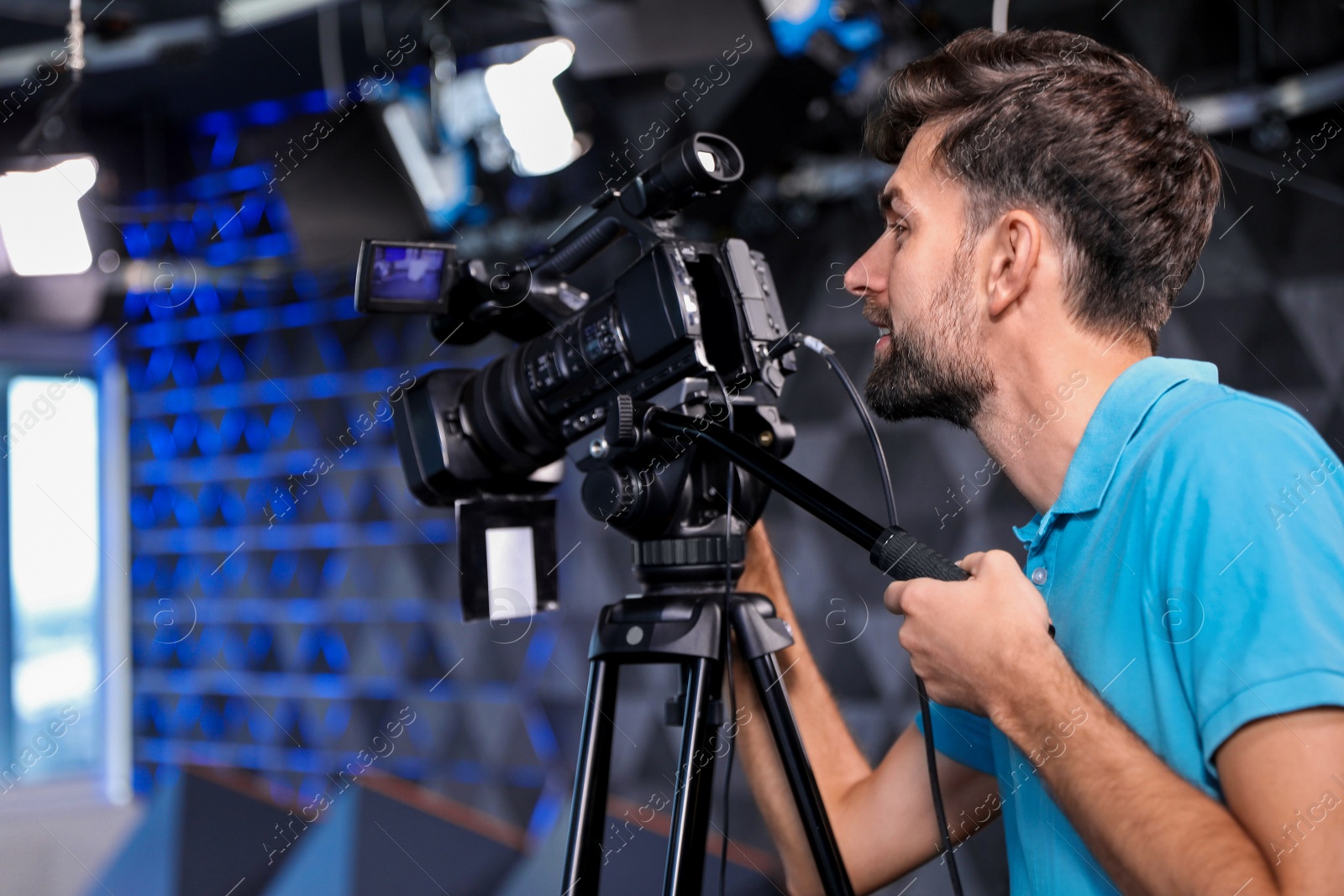 Professional video camera operator working in studio Photo of Professional video camera operator working in studio