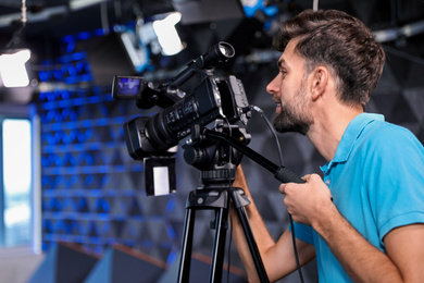 Professional video camera operator working in studio Photo of Professional video camera operator working in studio