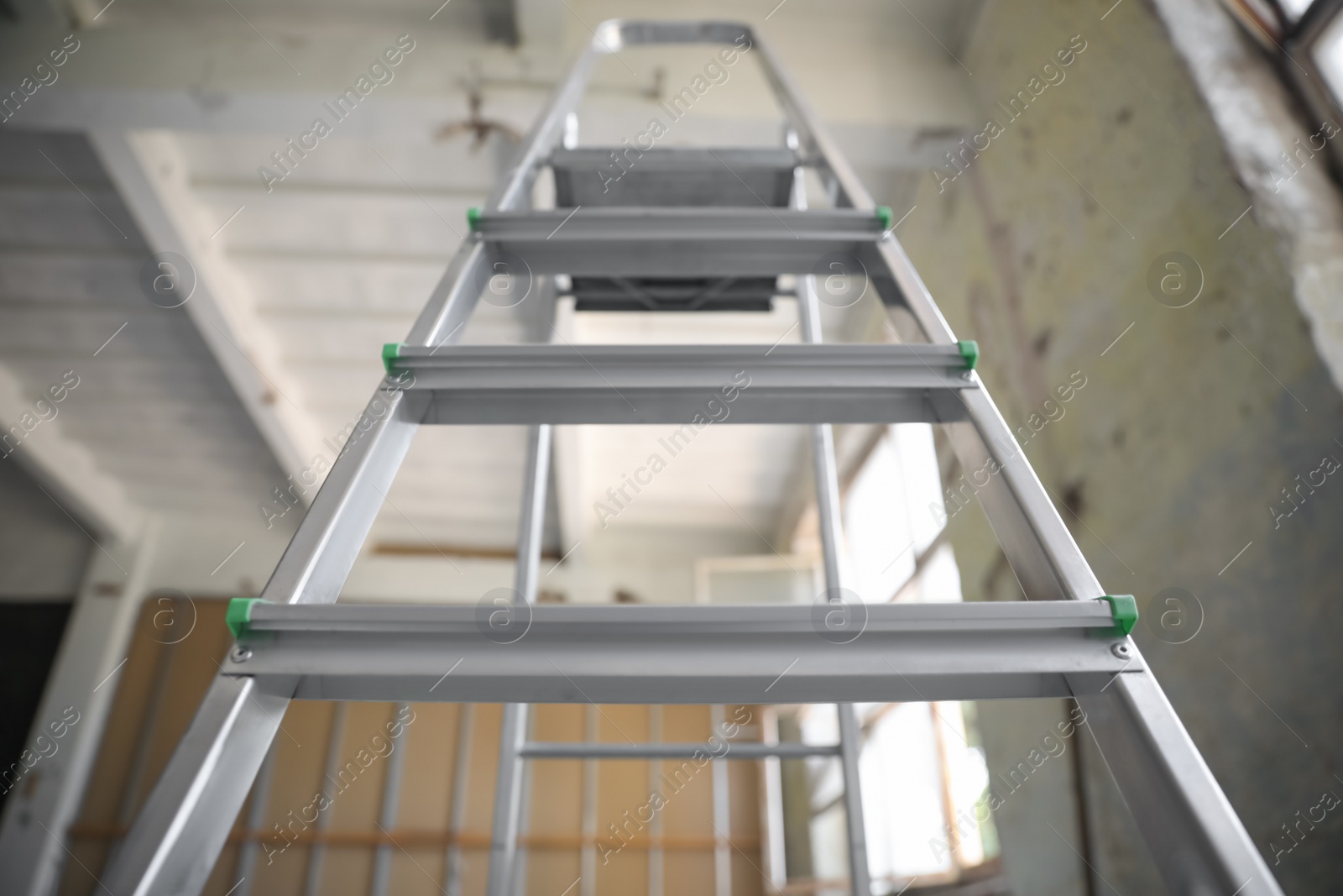 Metal ladder in old empty building, low angle view Photo of Metal ladder in old empty building, low angle view