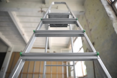 Metal ladder in old empty building, low angle view Photo of Metal ladder in old empty building, low angle view