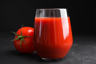 Delicious fresh tomato juice on black table, closeup Photo of Delicious fresh tomato juice on black table, closeup