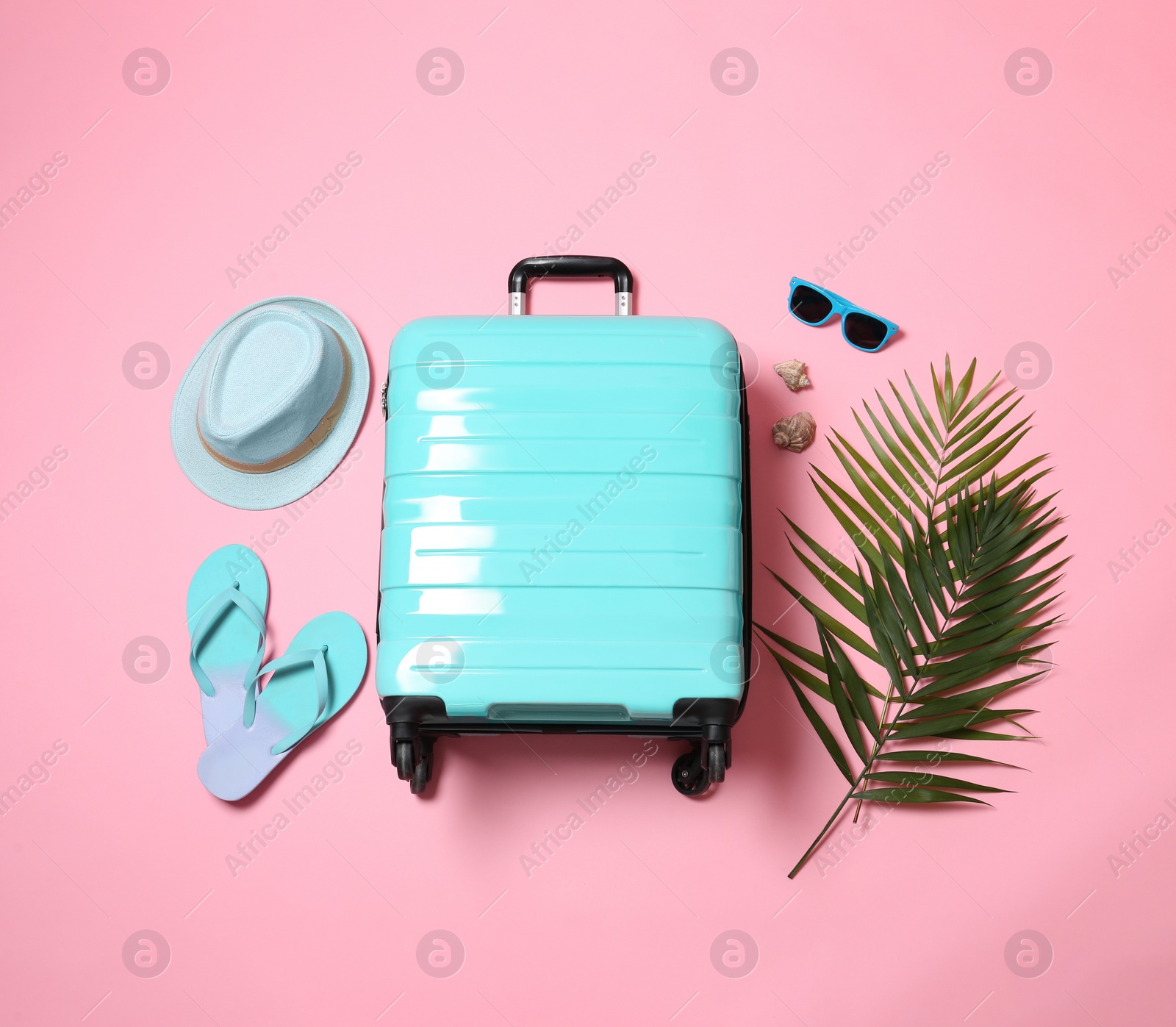 Photo of Flat lay composition with suitcase on pink background
