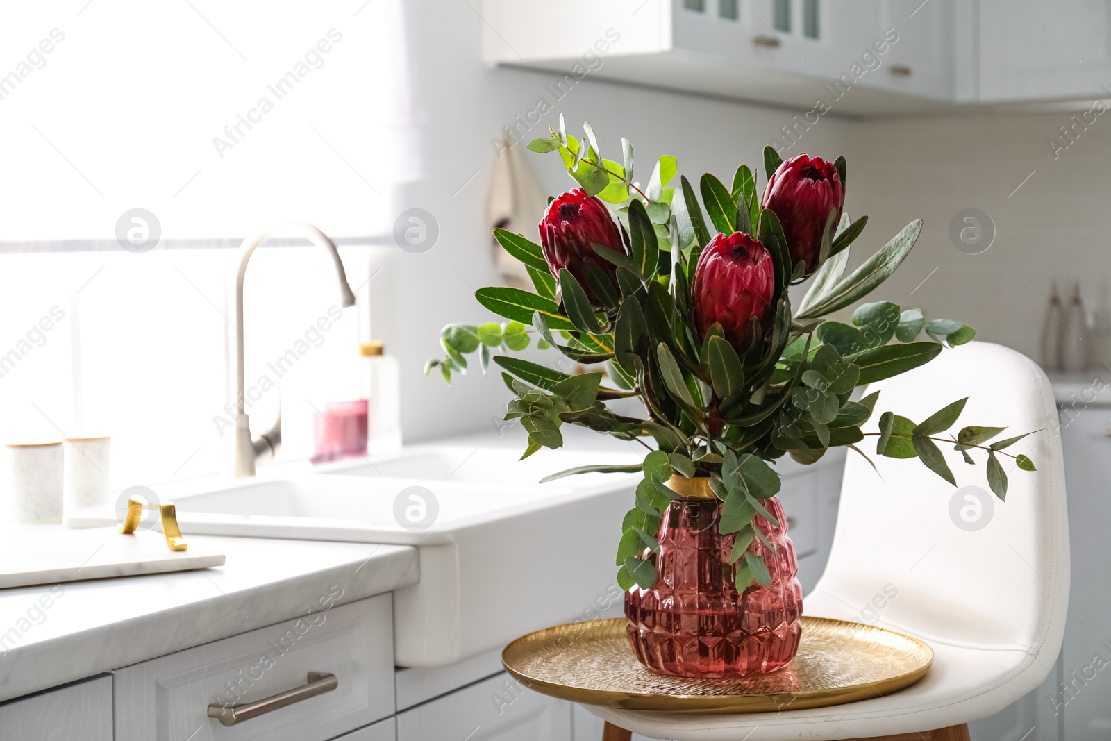 Bouquet with beautiful protea flowers in kitchen, space for text. Interior design Photo of Bouquet with beautiful protea flowers in kitchen, space for text. Interior design