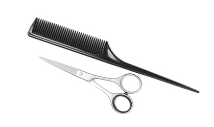 New scissors and comb on white background, top view. Professional tool for haircut Photo of New scissors and comb on white background, top view. Professional tool for haircut