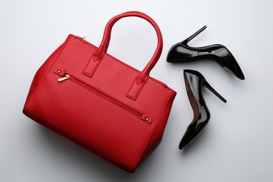 Stylish woman's bag and shoes on light background, flat lay Photo of Stylish woman's bag and shoes on light background, flat lay