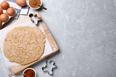 Making homemade Christmas cookies on grey marble table, flat lay with space for text. Gingerbread men Photo of Making homemade Christmas cookies on grey marble table, flat lay with space for text. Gingerbread men