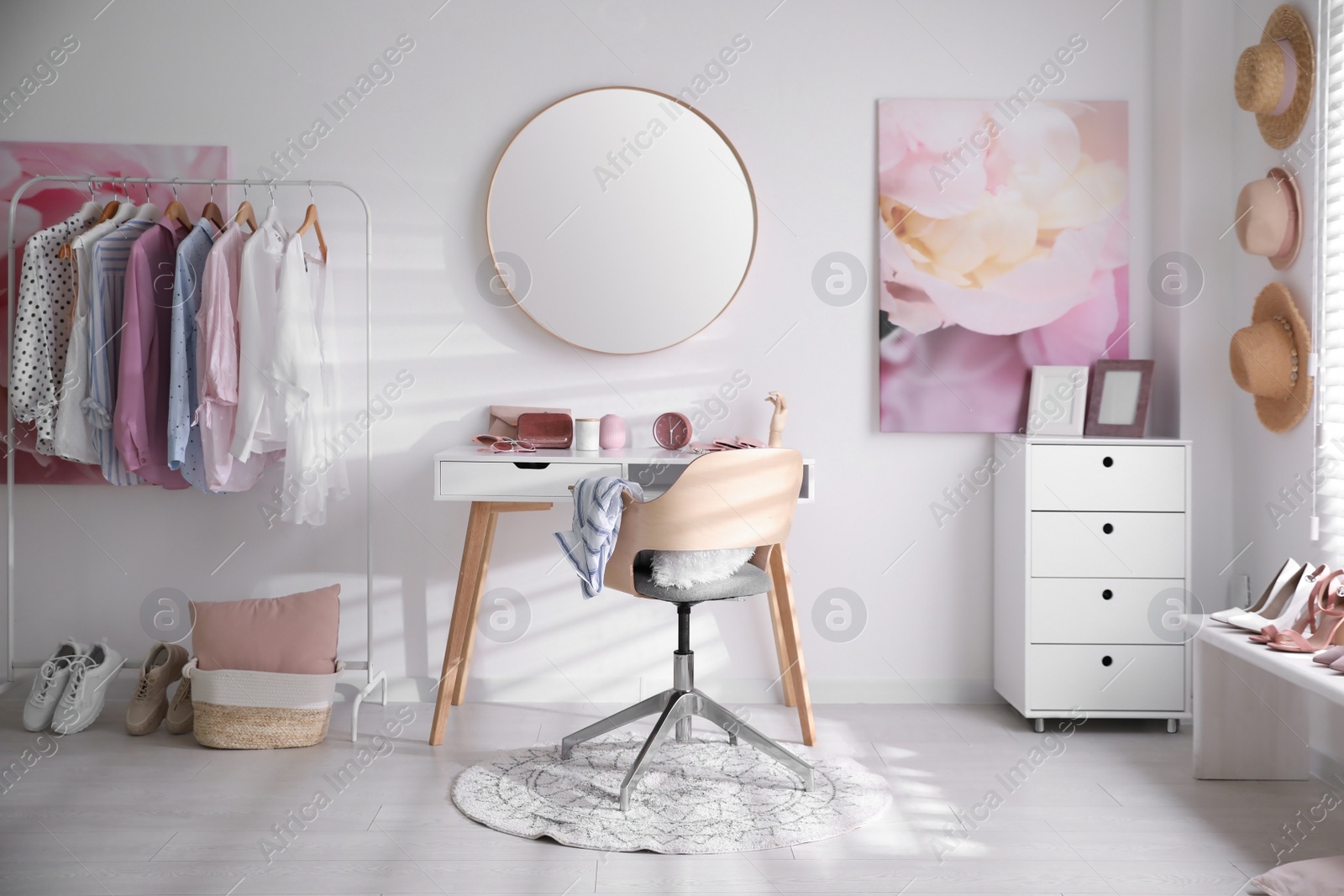 Dressing room interior with stylish makeup table, clothes and accessories Photo of Dressing room interior with stylish makeup table, clothes and accessories