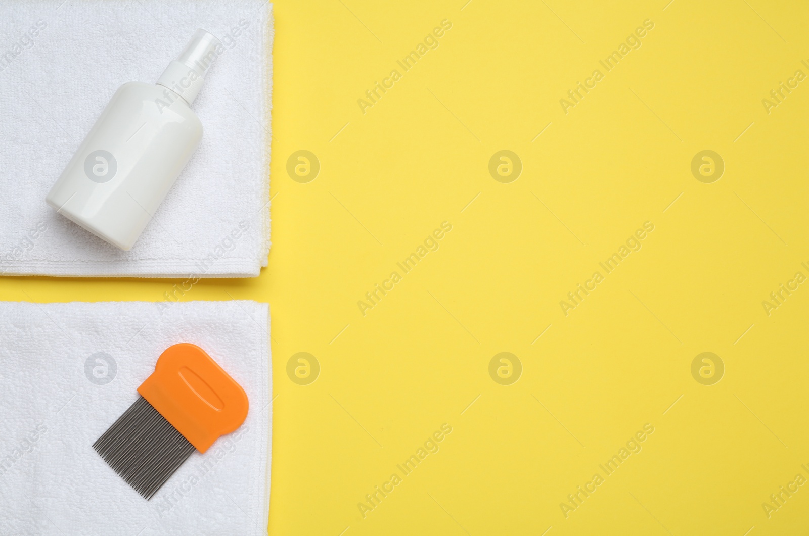 Comb, anti lice spray and towels on yellow background, flat lay. Space for text Photo of Comb, anti lice spray and towels on yellow background, flat lay. Space for text