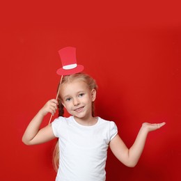 Cute little girl with red hat prop on red background. Christmas celebration Image of Cute little girl with red hat prop on red background. Christmas celebration